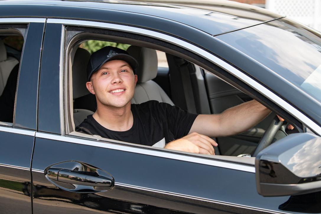 Student drives a car on campus to find a parking spot.